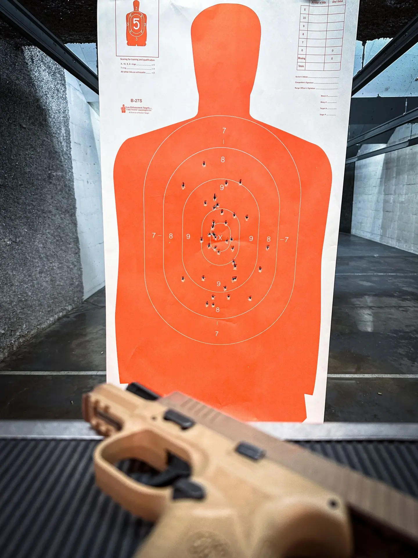 Paper silhouette target with bullet holes from range practice